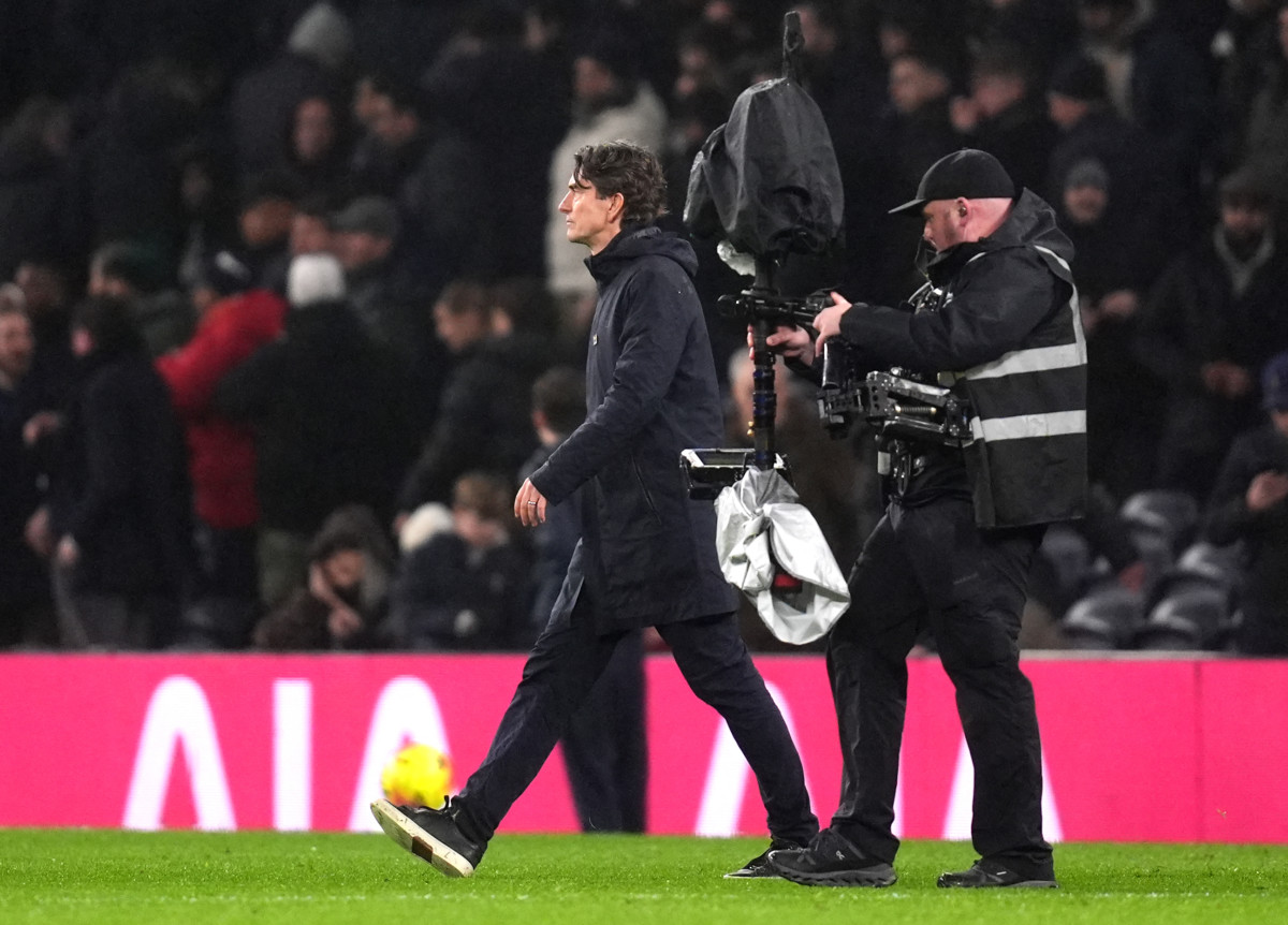 Thomas Frank walks across the pitch, tracked by a television cameraman, after Tottenham's loss to Newcastle