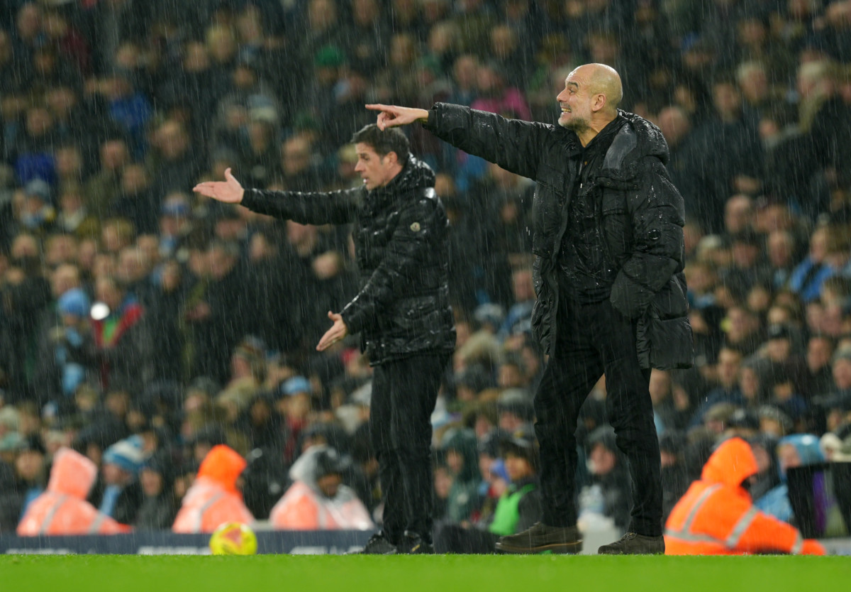Marco Silva (left) and Manchester City manager Pep Guardiola shout instructions