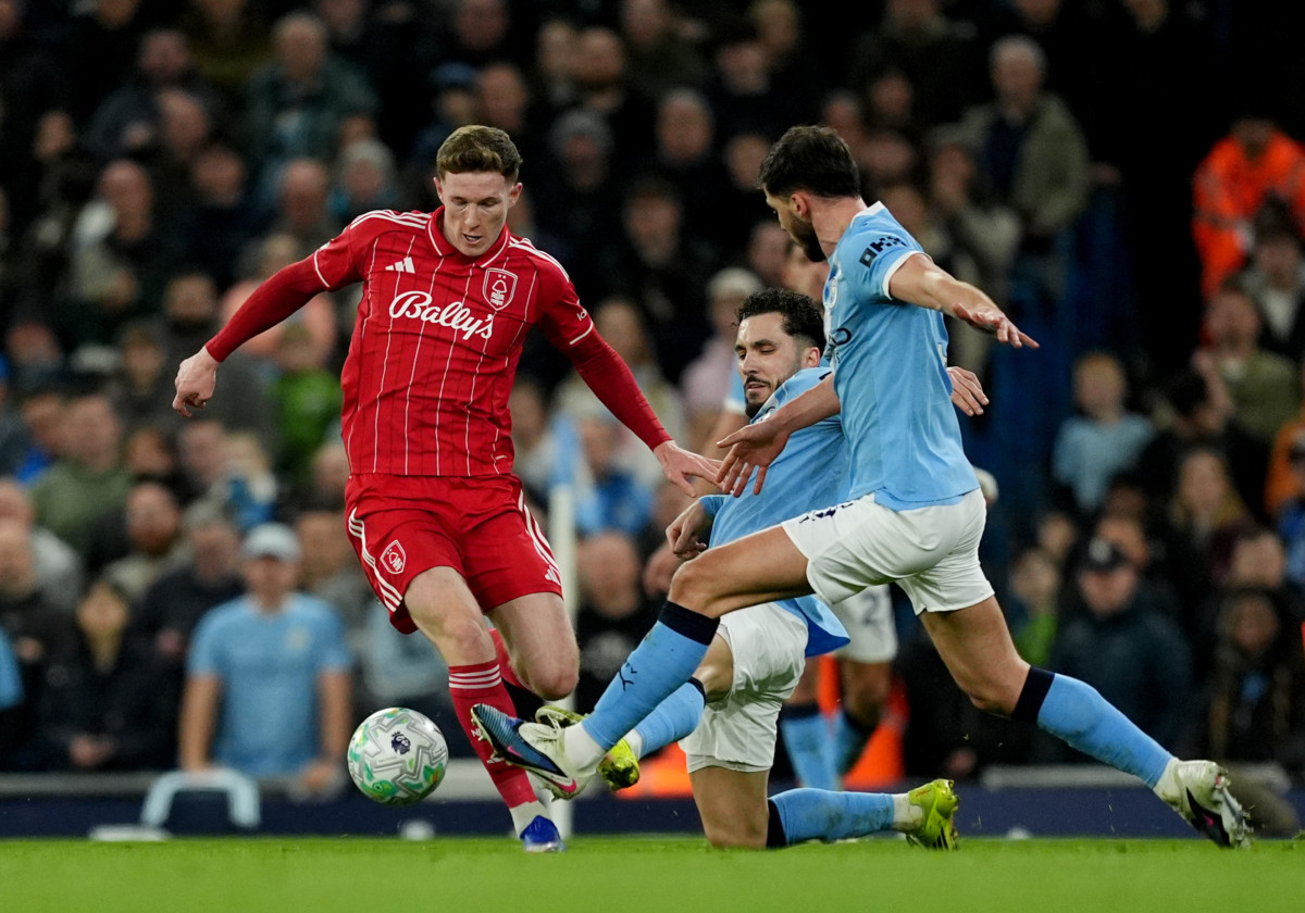 Nottingham Forest’s Elliot Anderson (left) battles for the ball with Manchester City’s Rayan Cherki (rear right) and Manchester City’s Ruben Dias 