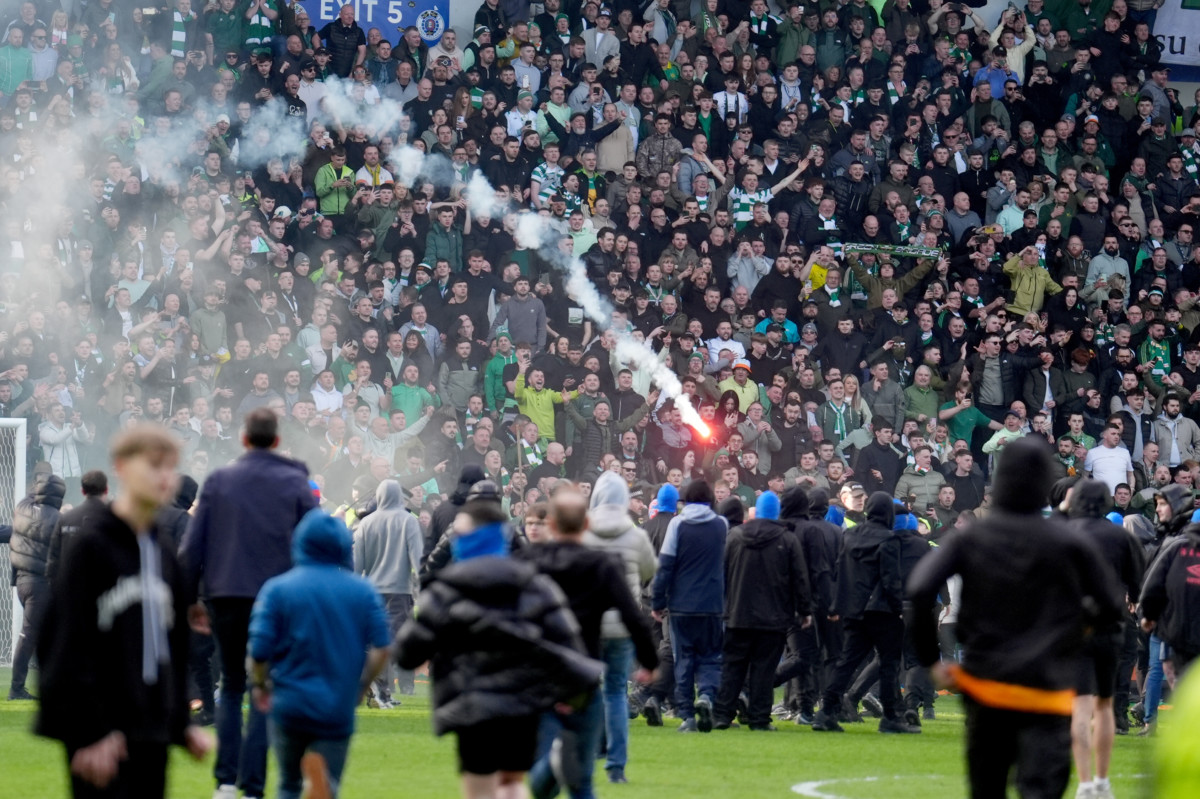 Rangers fans charge towards the Celtic end 